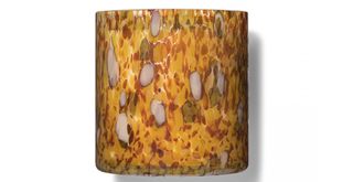 Amber colored glass vessel candle featured in the best scented candle buying guide