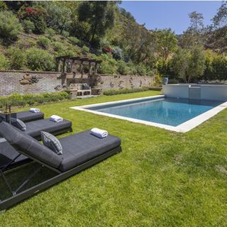 pool area with swimming pool and poolside chairs