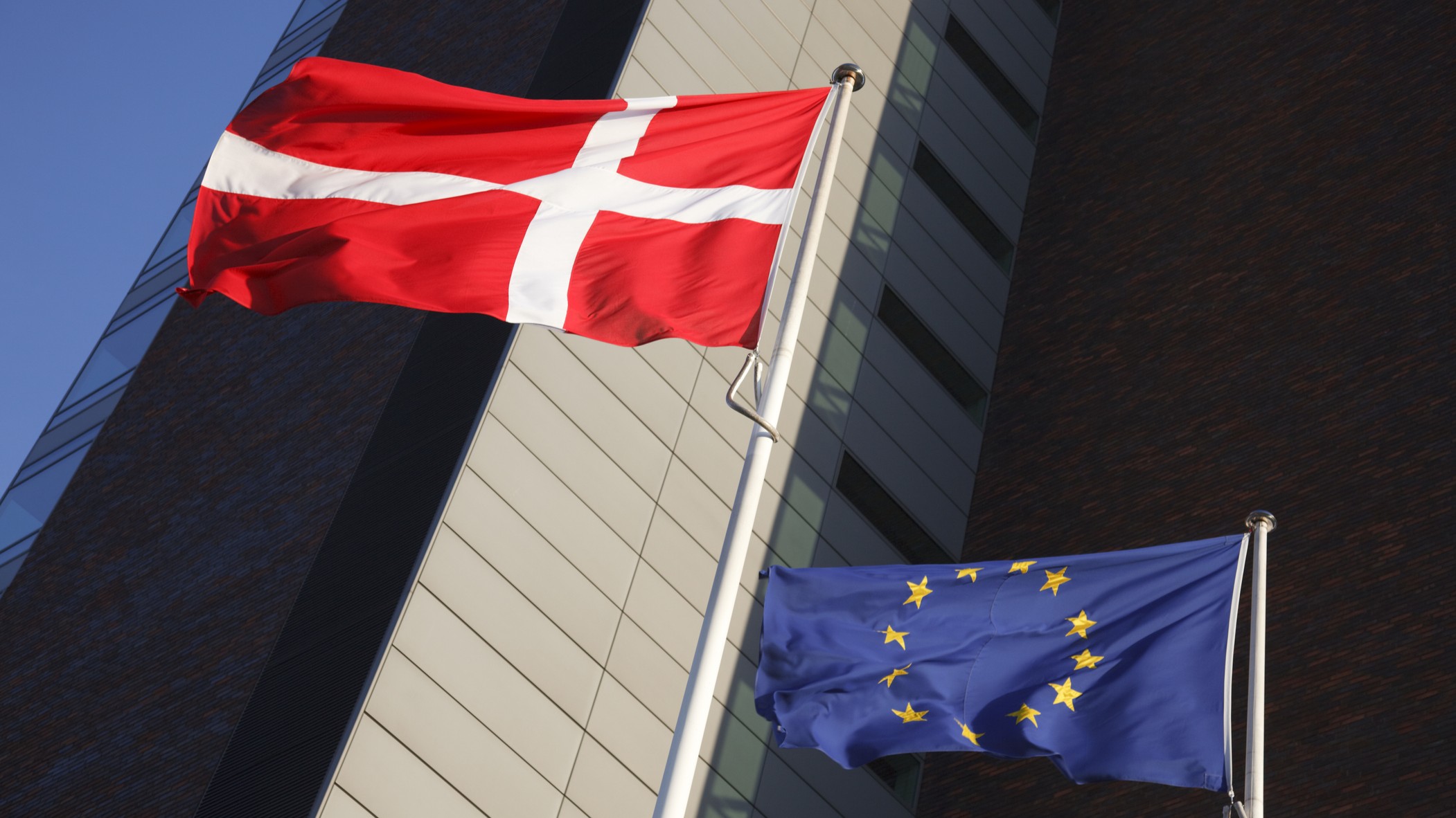 The European Union flag and the Danish national flag side by side.
