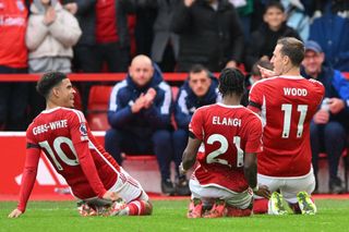 Morgan Gibbs-White and Anthony Elanga of Nottingham Forest slide on their knees as Chris Wood of Nottingham Forest celebrates after scoring a goal during the Premier League match between Nottingham Forest and Luton Town at the City Ground, Nottingham on Saturday 21st October 2023