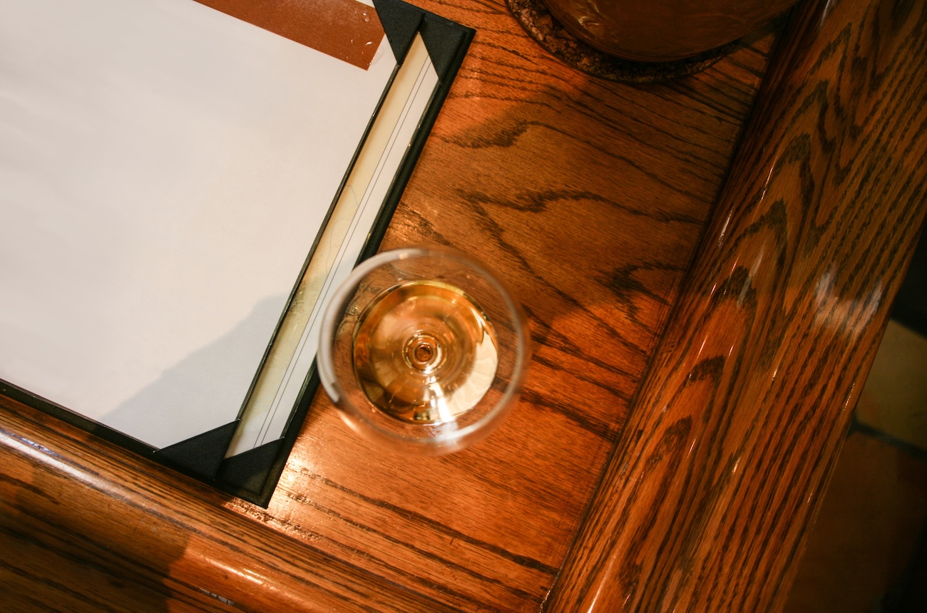 wine glass next to a book