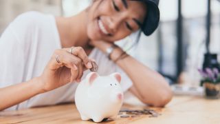 Piggy Bank for saving money.Hand holding money for savings and financial management.