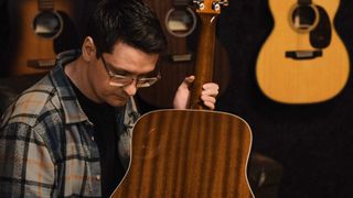 Customer looking over an acoustic guitar