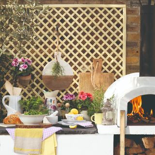 Outdoor kitchen with pizza oven and trellis