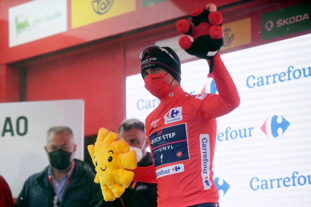 Team Quick Steps Belgian rider Remco Evenepoel celebrates on the podium wearing the overall leaders red jersey after the 6th stage of the 2022 La Vuelta cycling tour of Spain a 1812 km race from Bilbao to San Miguel de Aguayo on August 25 2022 Photo by Ander GILLENEA AFP Photo by ANDER GILLENEAAFP via Getty Images