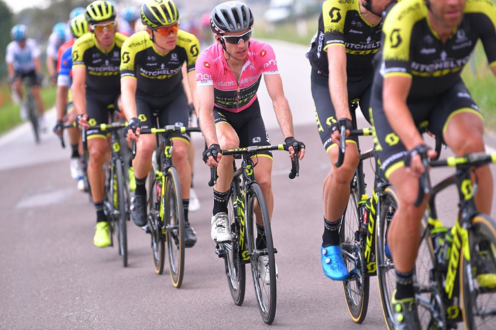 Simon Yates (Mitchelton-Scott) wears the pink leader's jersey and sits in the field during stage 13 at the Giro d'Italia
