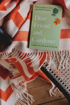 Dear Friend and Gardener: Letters on Life and Gardening, £9.99, by Beth Chatto, Christopher Lloyd and Fergus Garrett, from Waterstones.com; Nixon baby alpaca graphic print throw, £345, by Jonathan Adler, from Selfridges. Credit: Mariell Lind Handsen for American Express