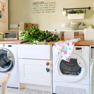 kitchen washing machine wooden counter with white cabinet