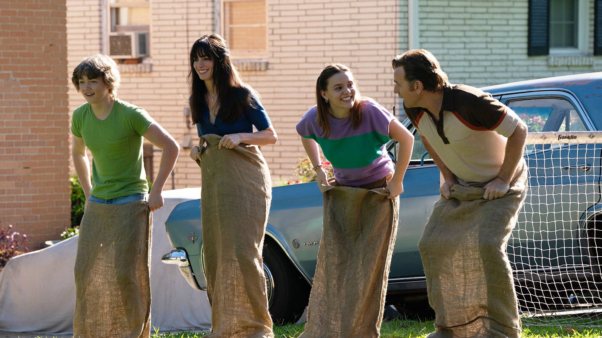CHRISTIAN CONVERY as Brian Platt, ANNE HATHAWAY as Denise Platt, MAISY STELLA as Audrey Platt and EWAN McGREGOR as Greg Platt in "The End of Oak Street" movie
