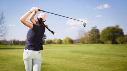 Generic image of a female golfer taking a shot