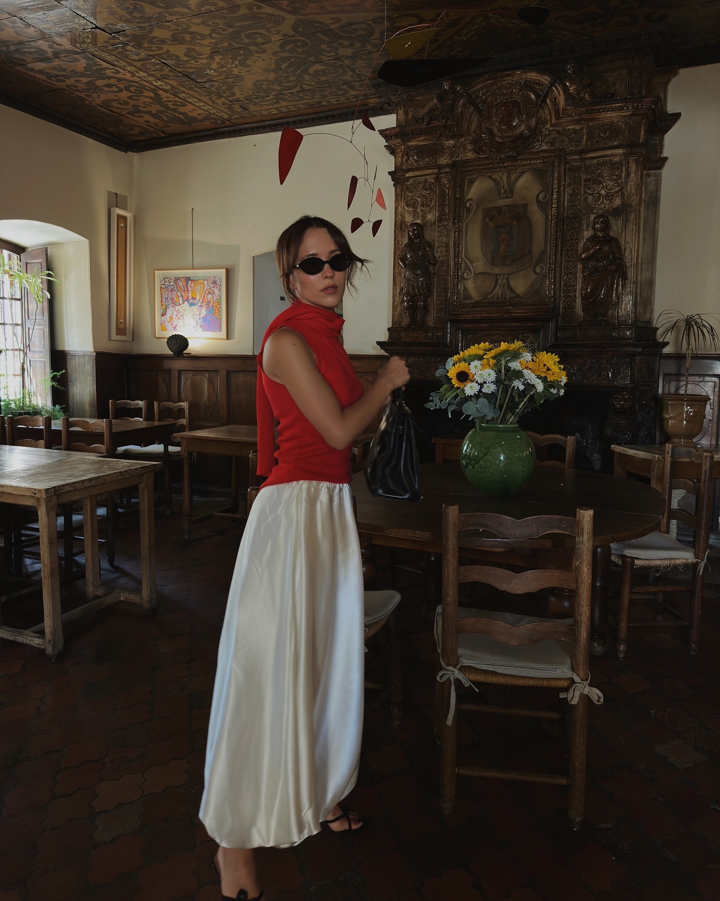 Influencer wears a cream satin skirt.