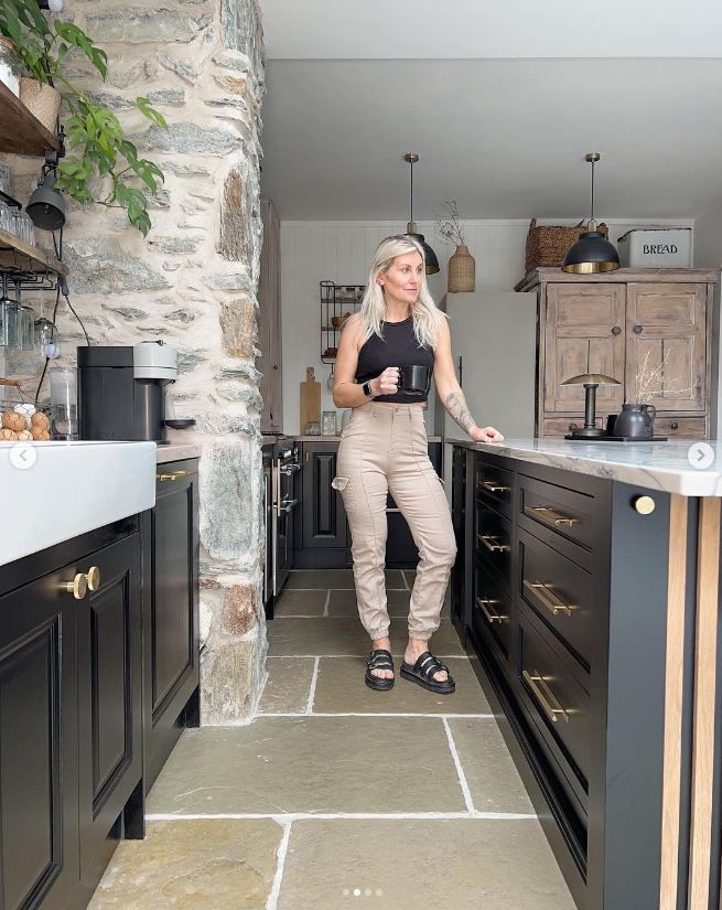 Jade Doutch having a cup of tea in her kitchen