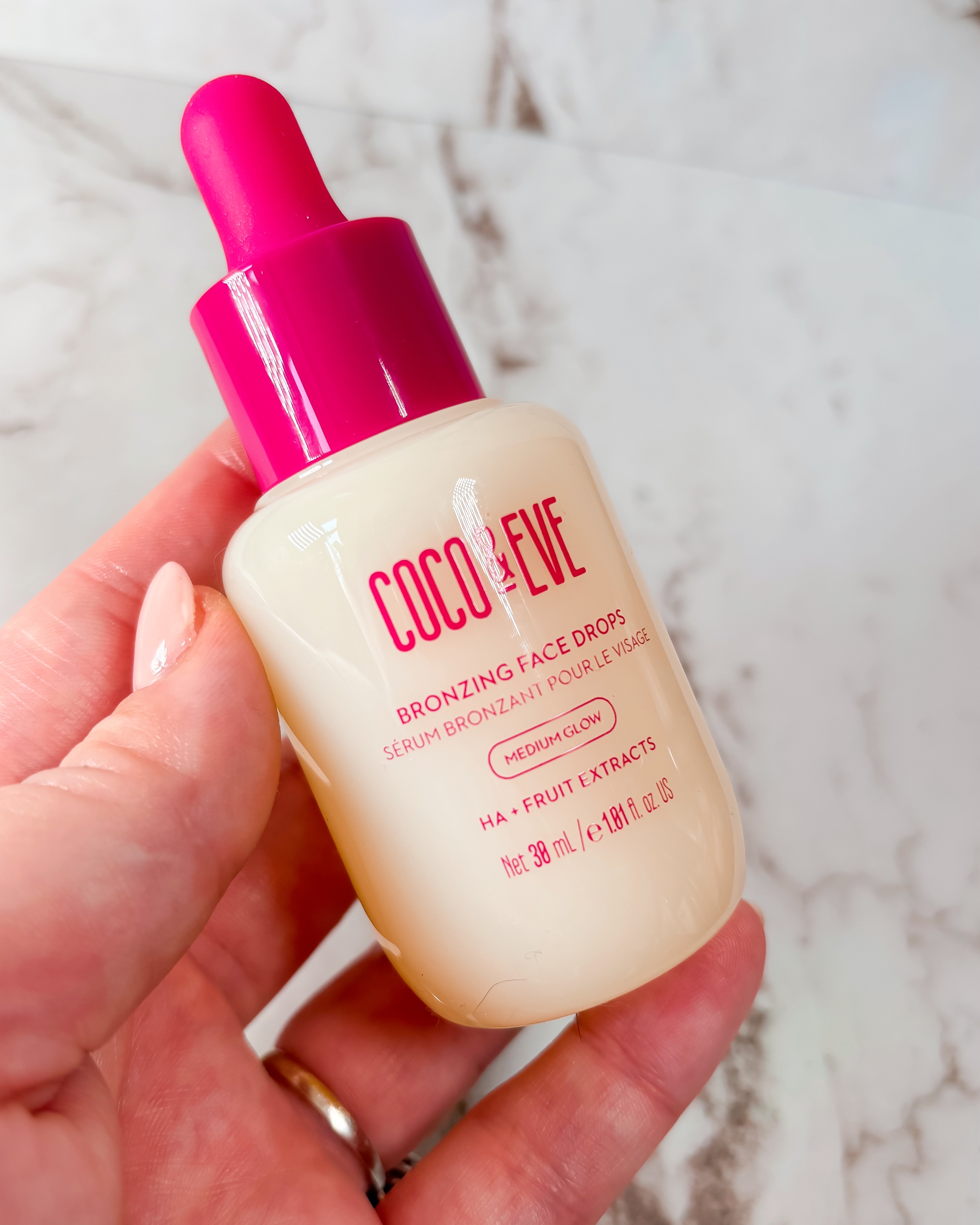 A close-up photograph of Coco & Eve's Bronzing Face Drops