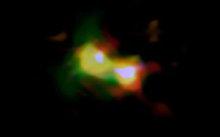 A composite image of the object B14-65666 shows the distributions of dust (red), oxygen (green) and carbon (blue), observed by ALMA. Stars (white) were observed by the Hubble Space Telescope.