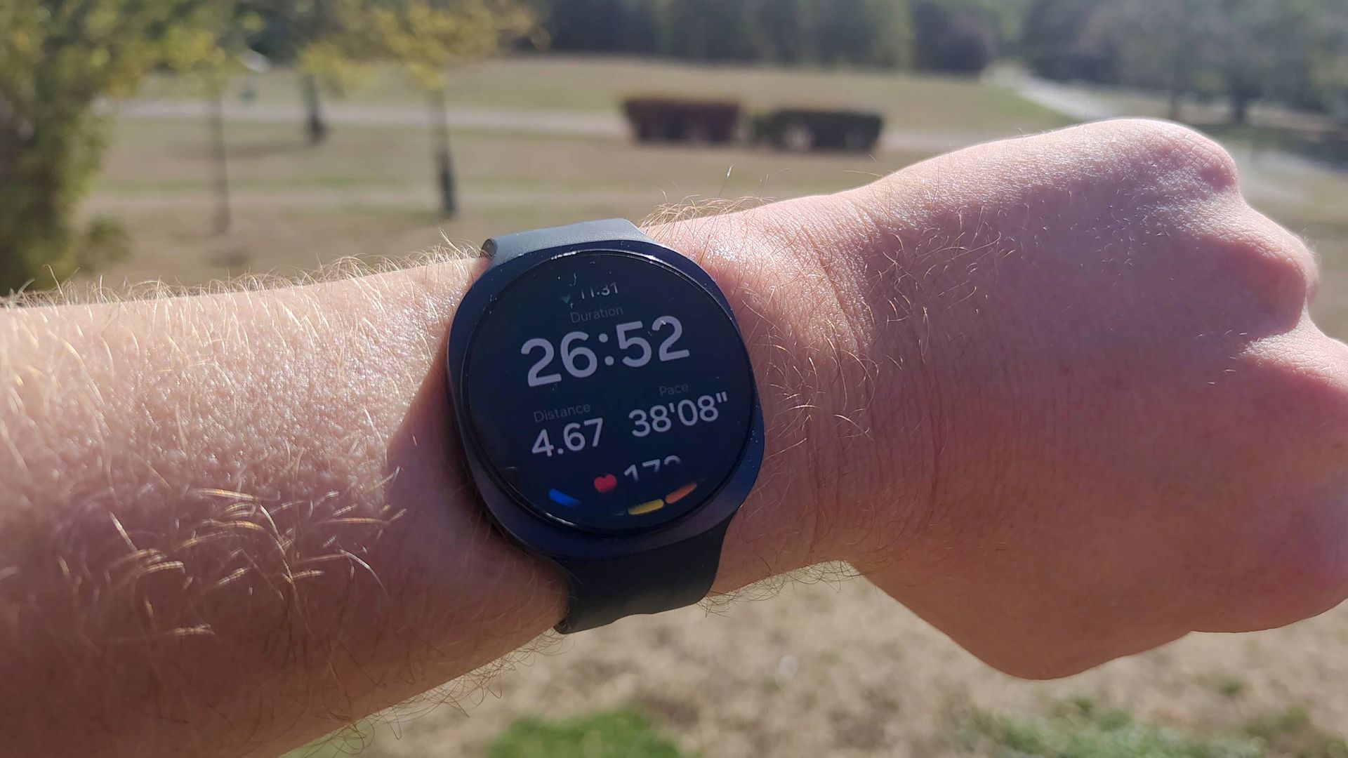 The Samsung Galaxy Watch 9 showing mid-run tracking metrics.