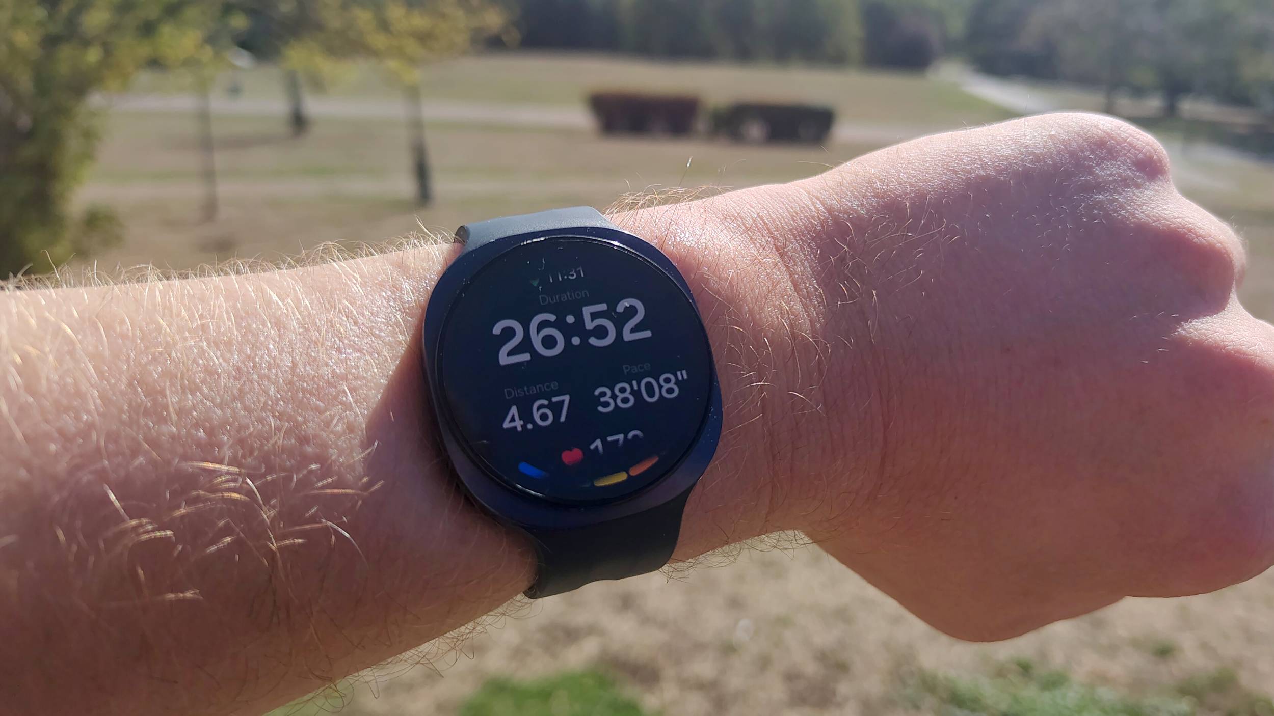 The Samsung Galaxy Watch 9 showing mid-run tracking metrics.