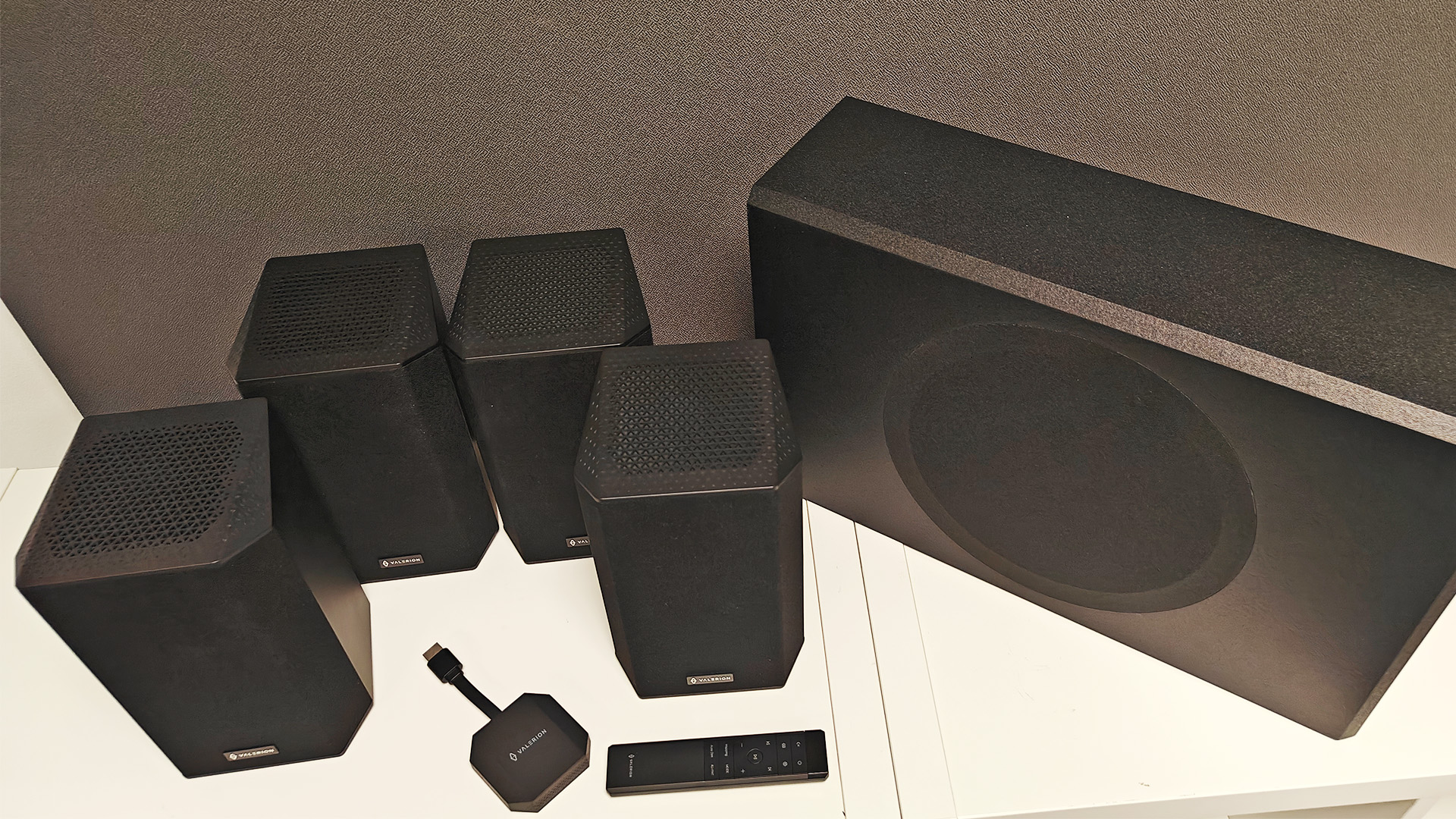 Valerion Thunderbeat 4.1.2 surround sound system on white wooden shelving units
