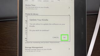 A Kindle Oasis with "OK" highlighted on the Update your Kindle screen