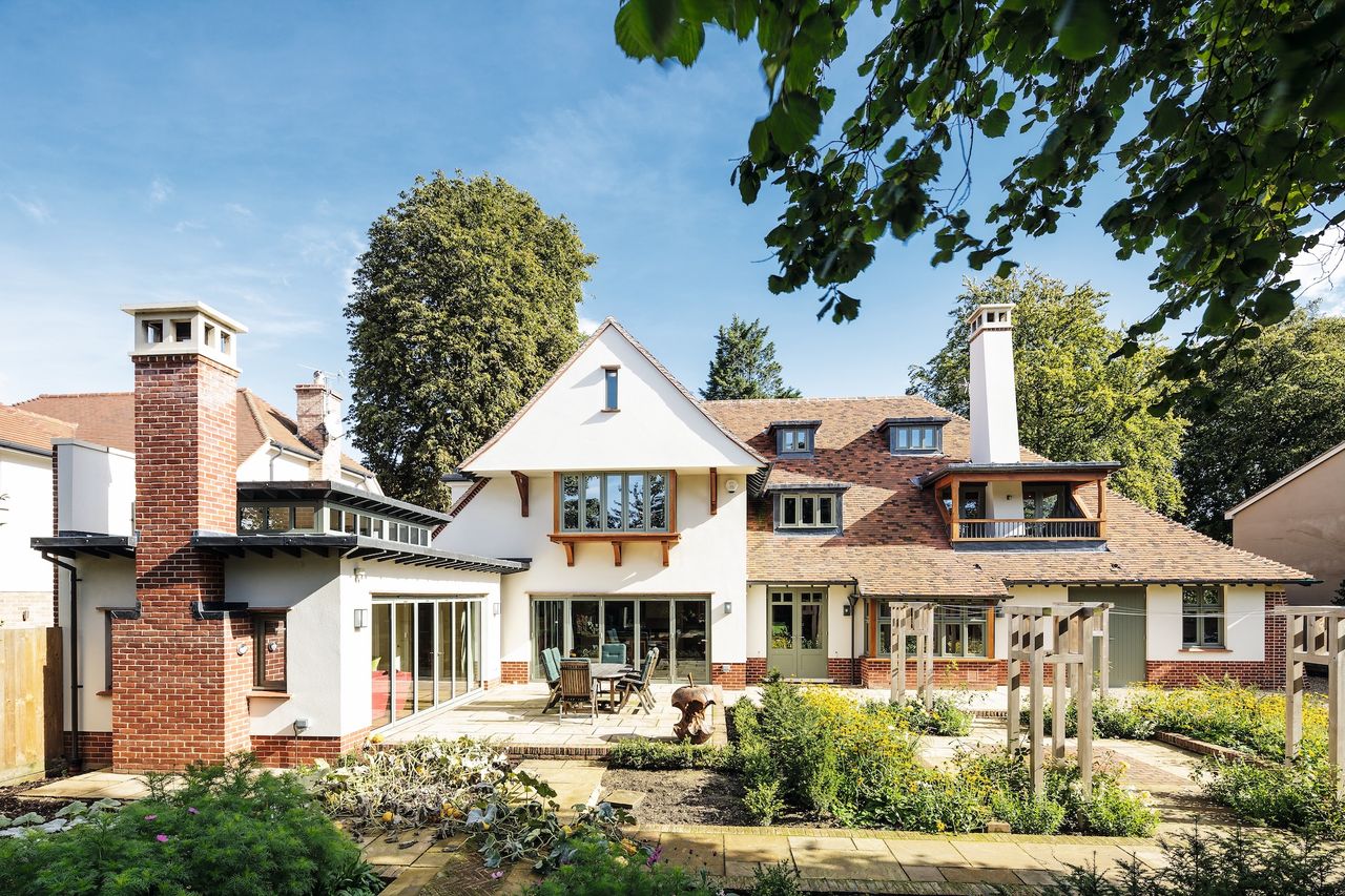 large arts and crafts style house with front garden and dormer windows