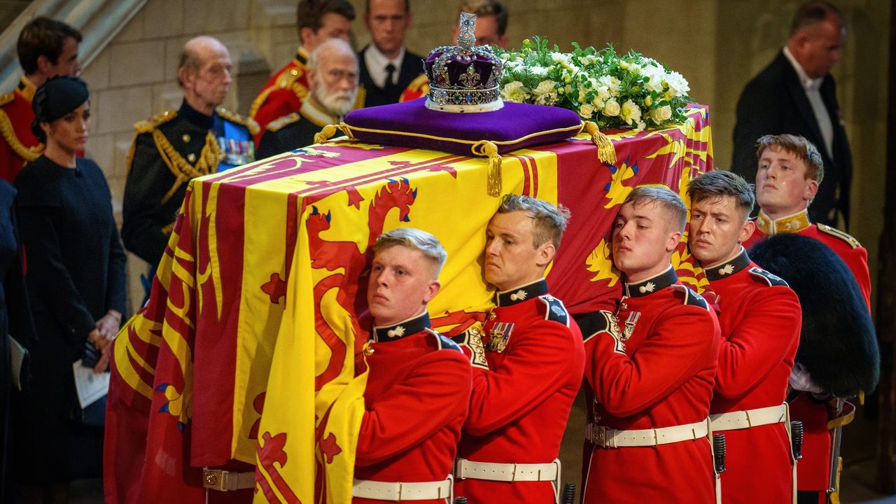 The coffin of Queen Elizabeth II is carried into The Palace of Westminster by guardsmen from The Queen&#039;s Company, 1st Battalion Grenadier Guards during the procession for the Lying-in State of Queen Elizabeth II on September 14, 2022 in London, England.