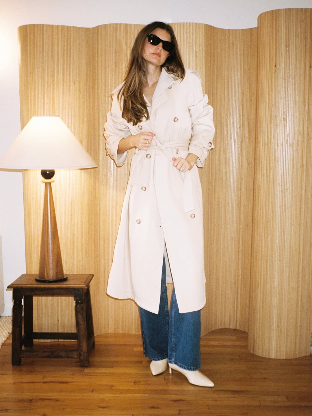 Woman wearing bootcut jeans with white ankle boots.