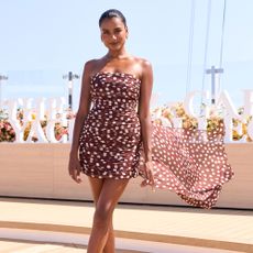 Simone Ashley wears a brown dress