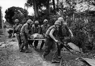 US Marines removing a comrade during the Battle of Hue, Hue, Vietnam, 1968