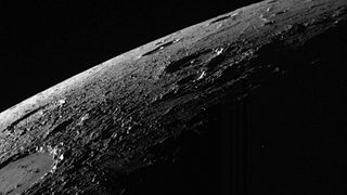 a black and white view of a part of a planet covered in craters