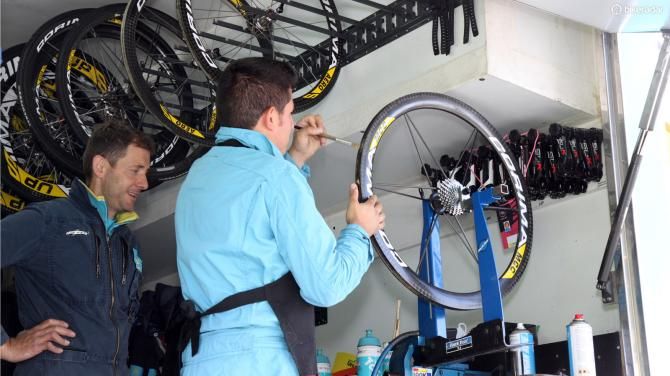 Astana team mechanics at least get to glue tubulars 'indoors' - hopefully with the rear door open