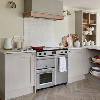 Cooking area of open-plan kitchen with range cooker, Cashmere coloured units and white worktops
