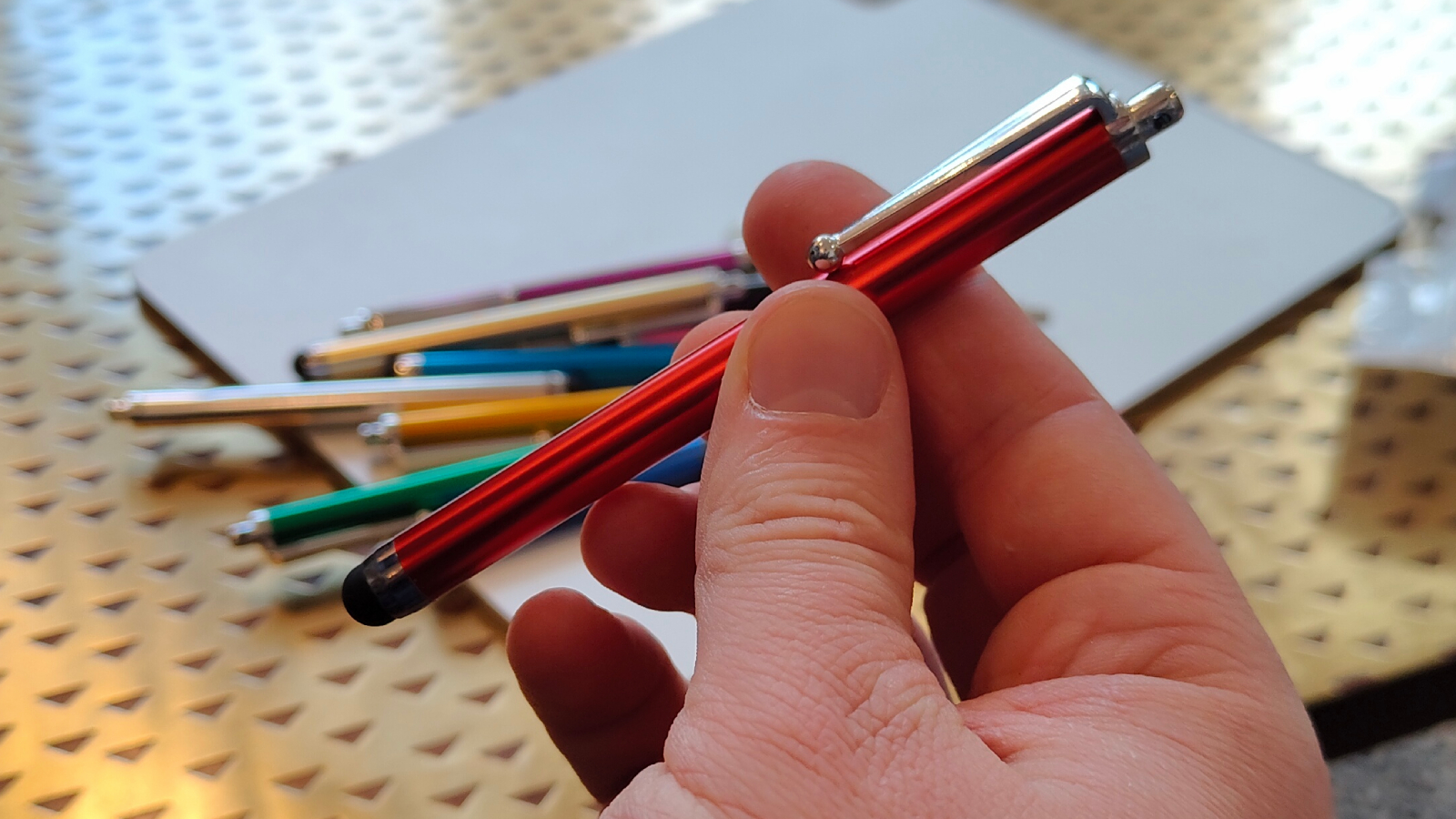 Yoonju's stylus pen held by a man.