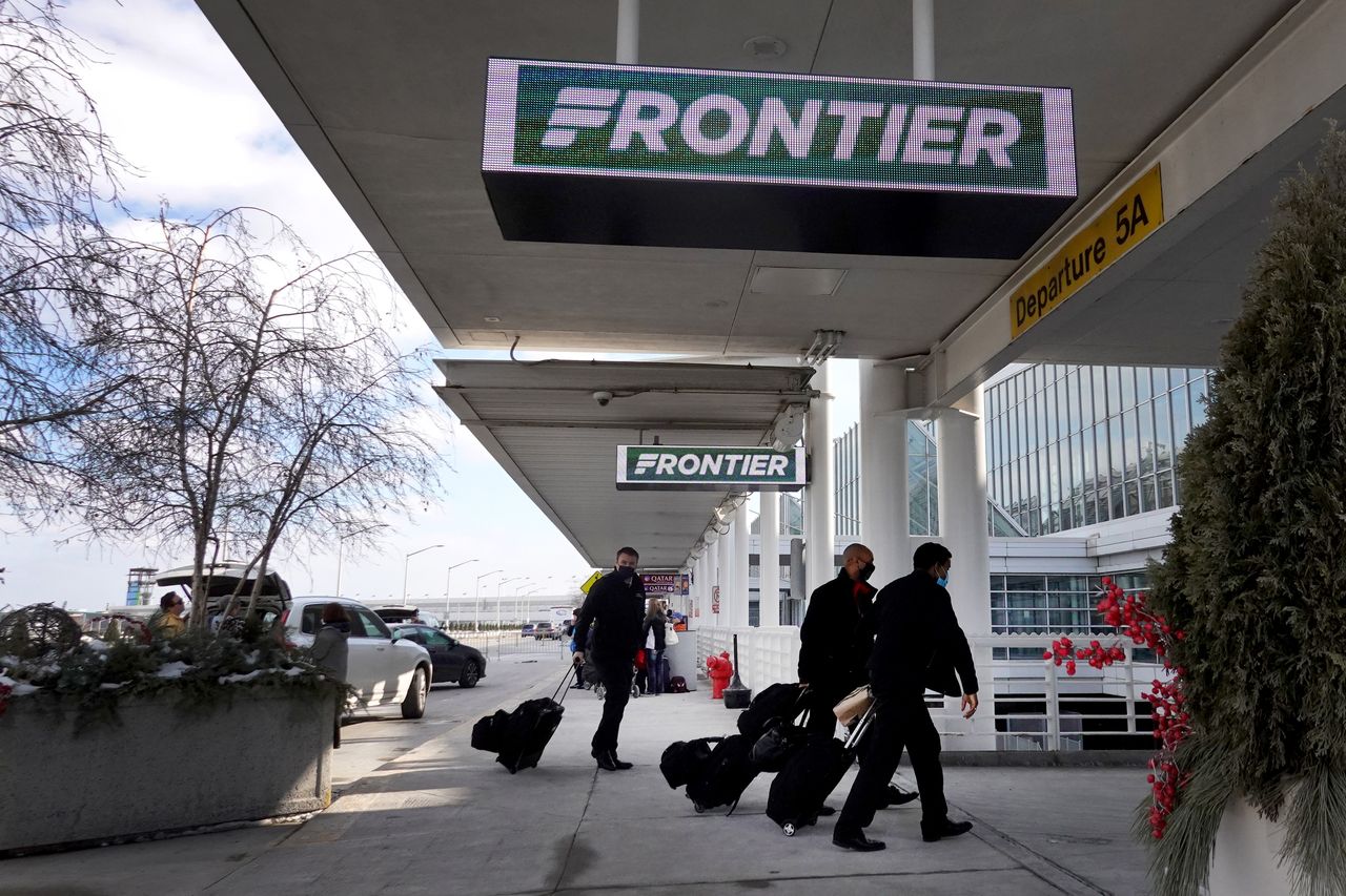 Passengers arrive for Frontier flights at Chicago&amp;#039;s O&amp;#039;Hare airport 