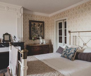 French country bedroom with ornate decorative paneling above the fireplace
