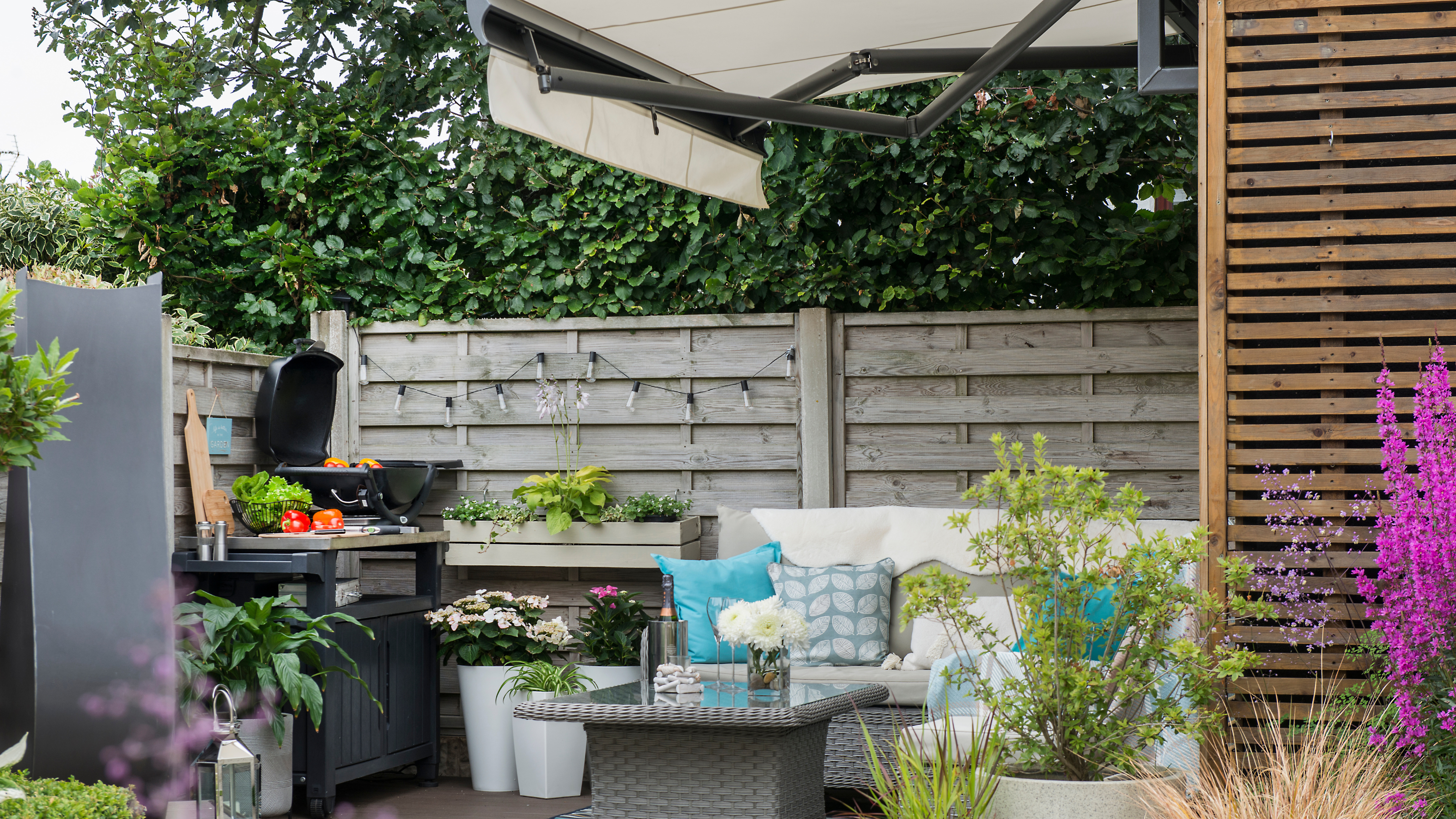 BBQ, garden furniture set, cream awning.