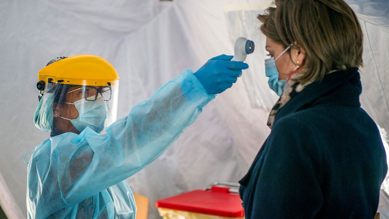 Nurse checking the temperature of a woman 