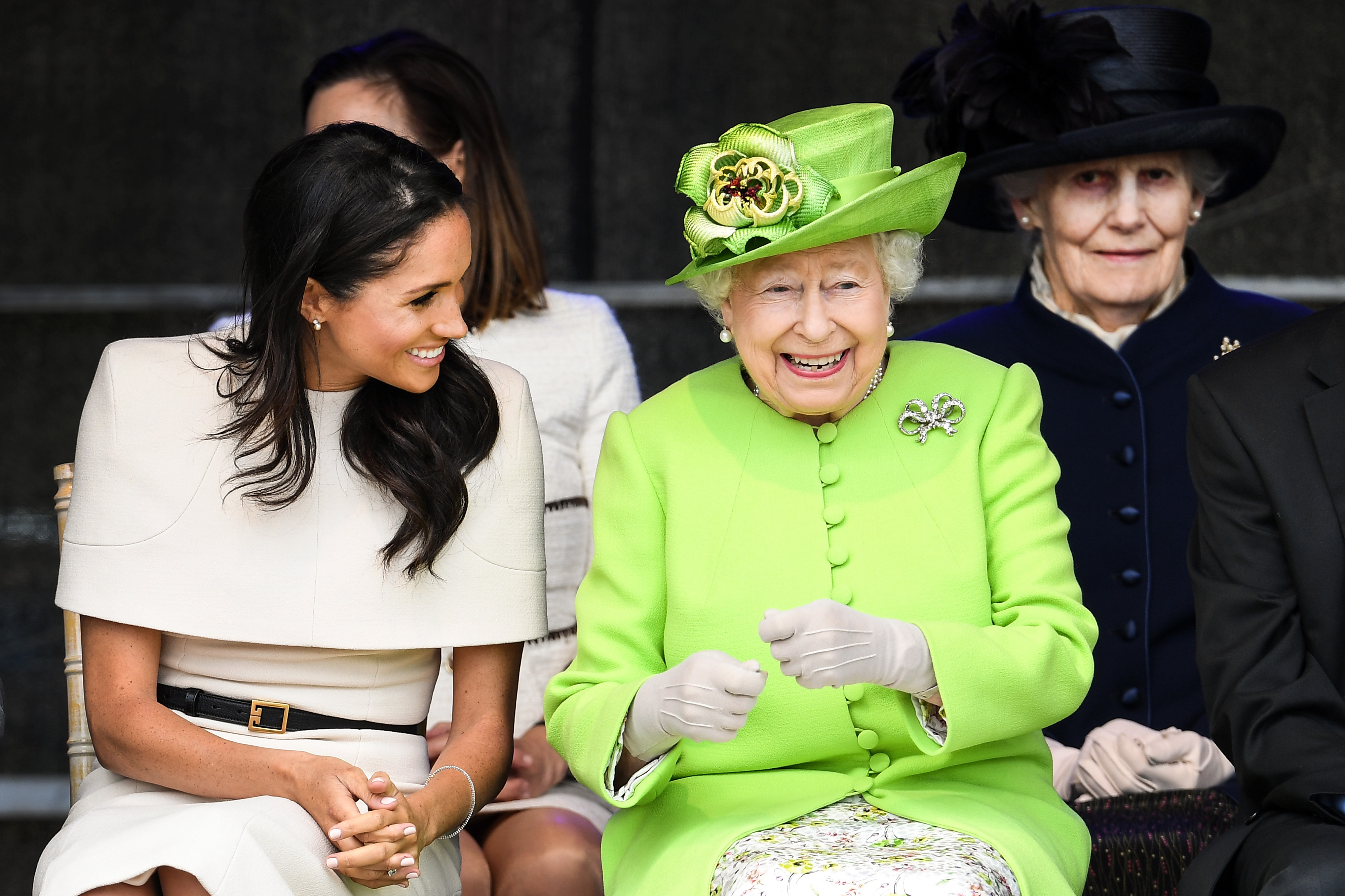 Meghan Markle wears a cream dress and attends a joint engagement with Queen Elizabeth, who wears a bright green coat, on June 14, 2018