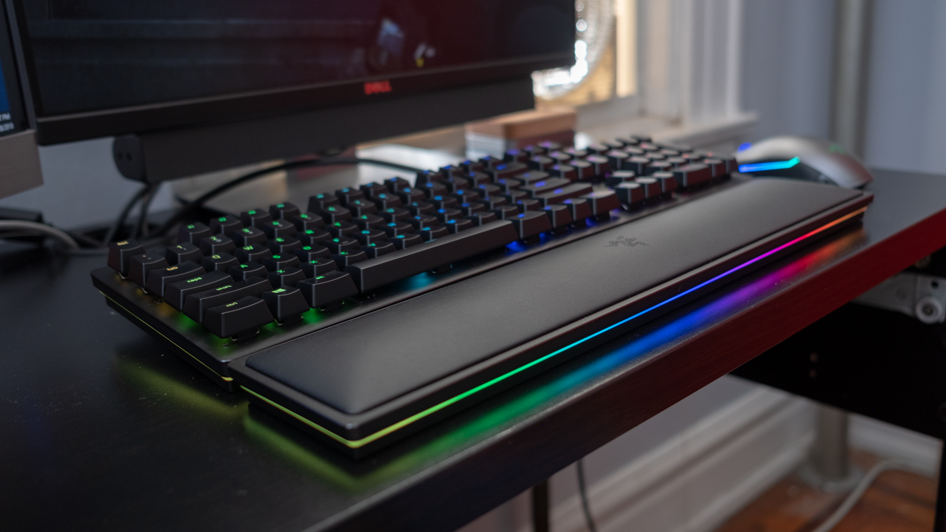 Razer Huntsman Elite showcasing its RGB light on a black desk