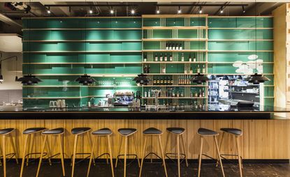 Bar with green walled shelves