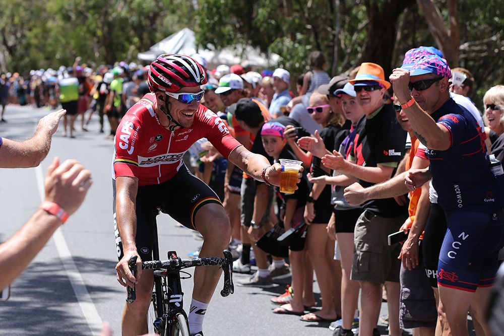 Adam Hansen takes a beer from a fan