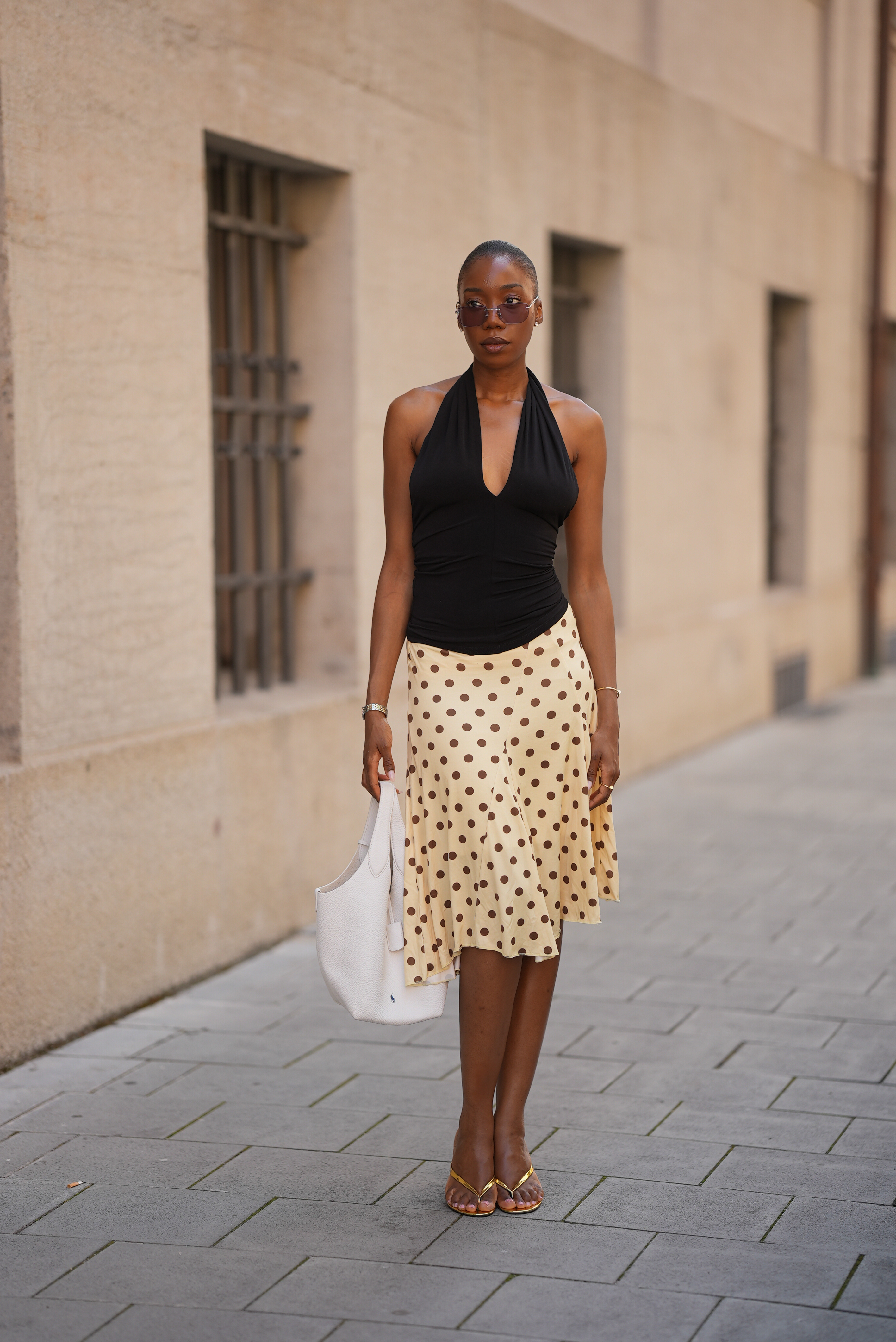 woman wearing a halter top and a polka dot skirt