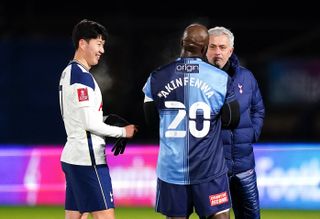 Jose Mourinho, right, talks to Wycombe's Adebayo Akinfenwa