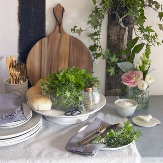 kitchen crockery with bread wooden board and rose flower