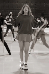 Taylor Swift wearing a skort and a sweatshirt