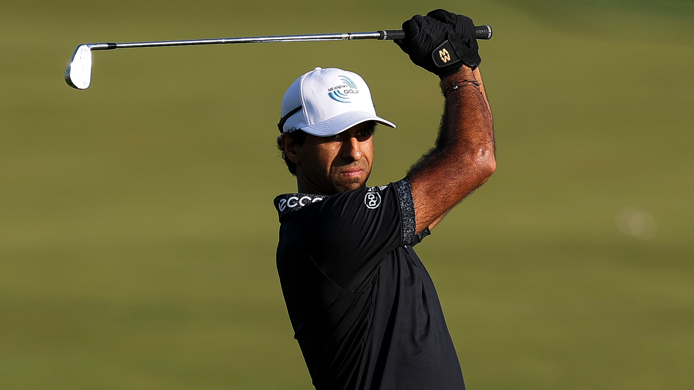 Aaron Rai holds his finish on an iron shot