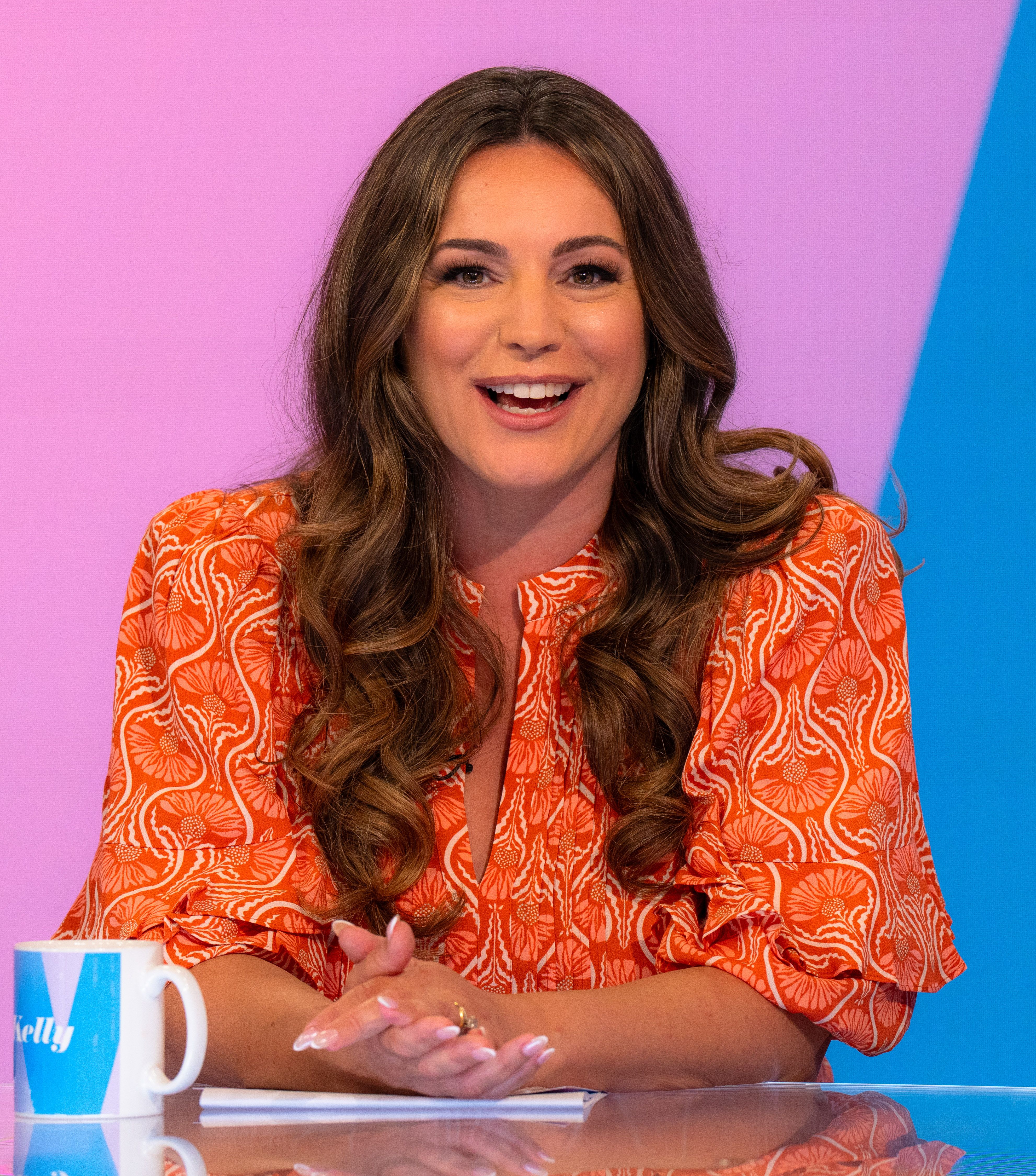 Kelly Brook on 'Loose Women' TV show in orange and white dress