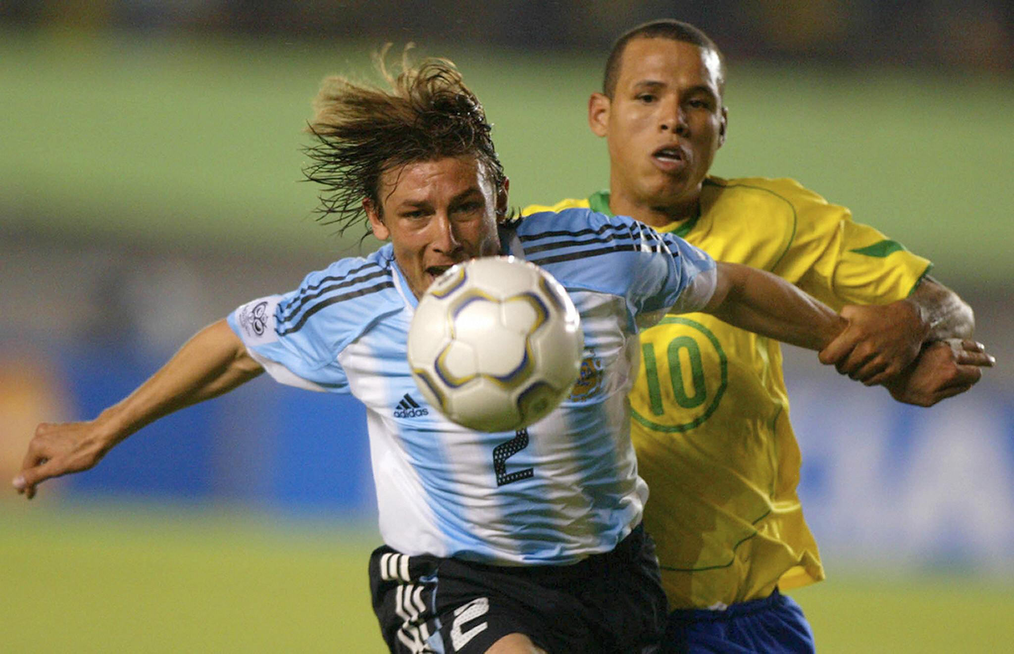 Argentina's Gabriel Heinze competes for the ball with Brazil's Luis Fabiano in a World Cup qualifier in June 2004.