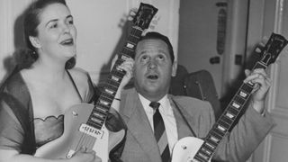 American musician and inventor Les Paul (1915 - 2009) and his wife Mary Ford (1924 - 1977) demonstrate two of Paul's new electric guitars during a press reception at the Savoy Hotel in London, 9th September 1952. 