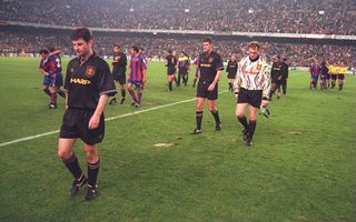 MANCHESTER UNITED's DENNIS IRWIN LEADS HIS TEAM OFF THE PITCH DEJECTED AFTER LOSING 4-0 TO BARCELONA IN THE CHAMPIONS LEAGUE MATCH AT THE NOU CAMP STADIUM IN BARCELONA, SPAIN.