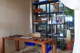 Studio interior featuring Nifemi's desk and shelves with books and ornaments.