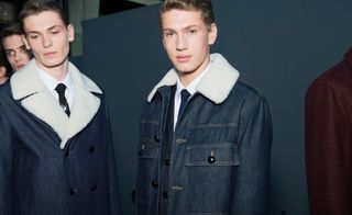 Males modelling denim jackets with white fluffy collars